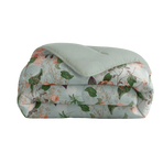 Floral patterned quilt with a green cover on a white background