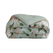 Floral patterned quilt with a green cover on a white background