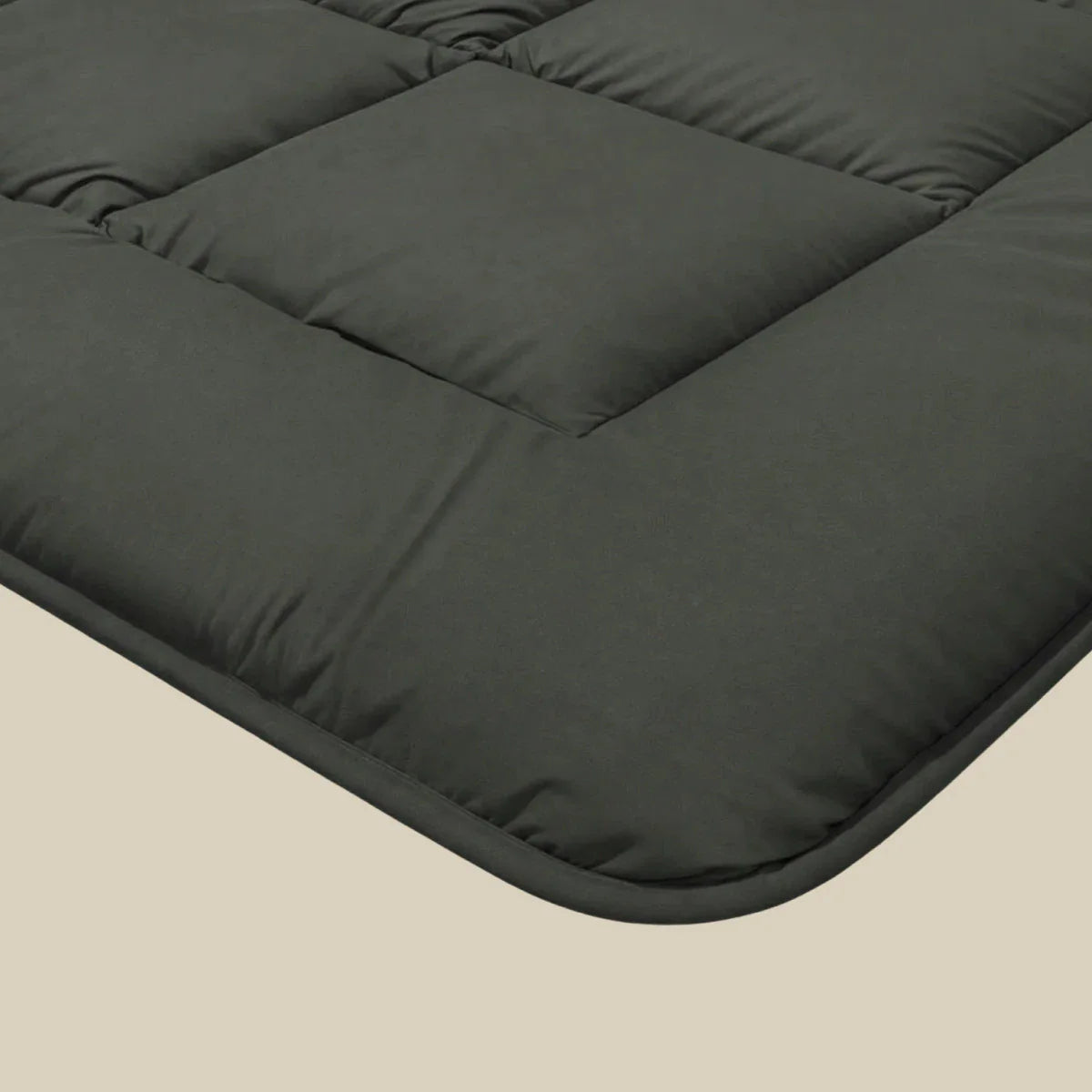 Close-up corner detail of the Zelesta Pure Uni Cotton Duvet in Olive Black showing the quilting and soft cotton fabric texture
