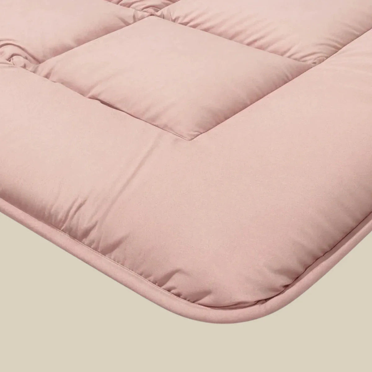 Close-up corner detail of the Zelesta Pure Uni Cotton Duvet in Soft Pink showing the quilting and soft cotton fabric texture