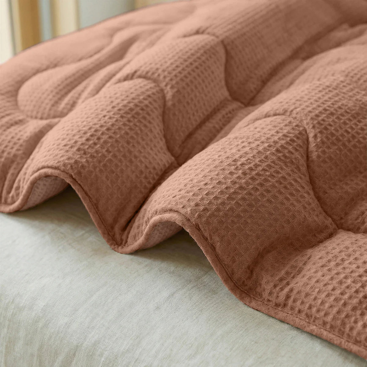 Close-up of the cooling fabric texture of the Zelesta Special Cooling Serene Summer Duvet in Terracotta Pink