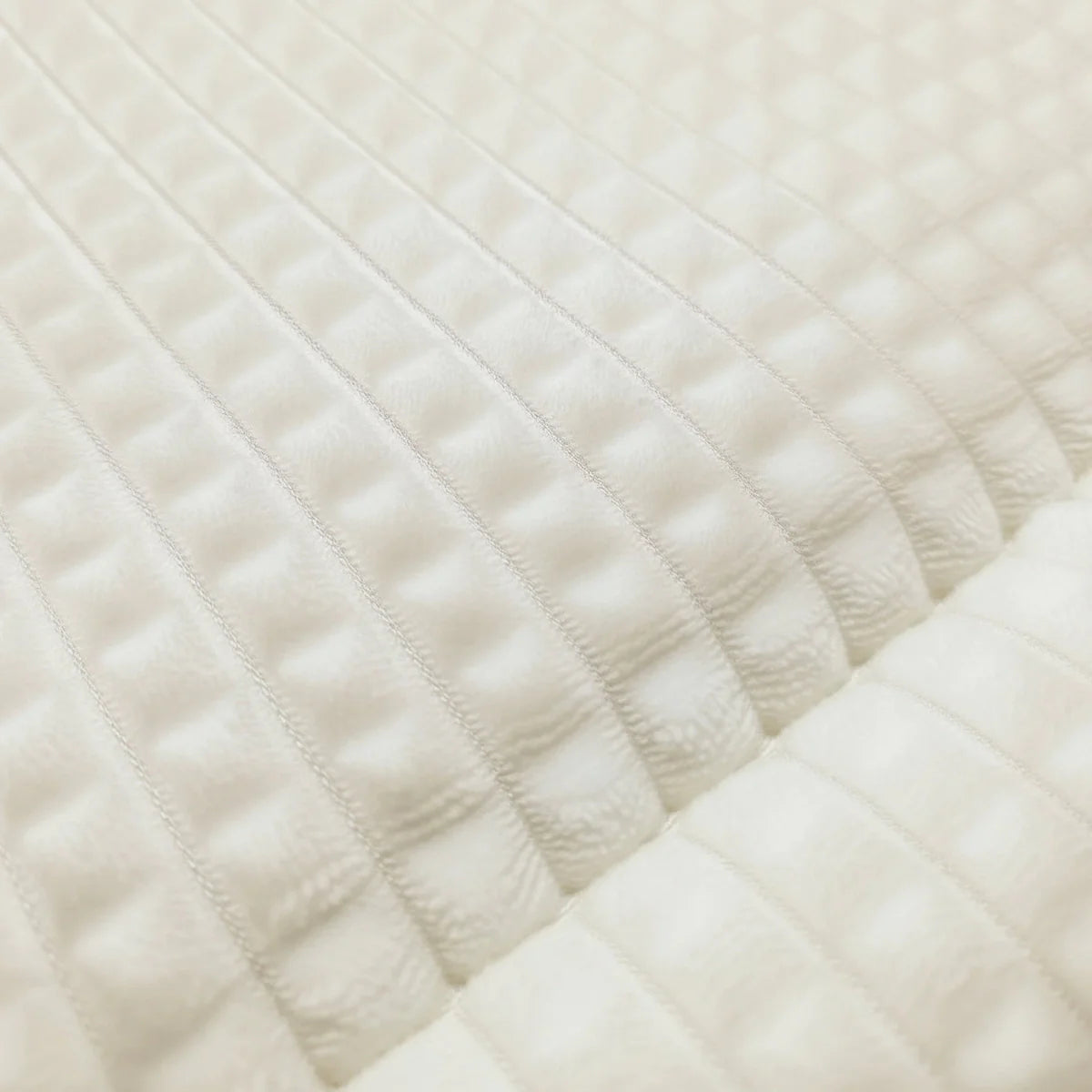 Close-up of the waffle-grid teddy fabric texture of the Zelesta Special Teddy Check Duvet in Cream