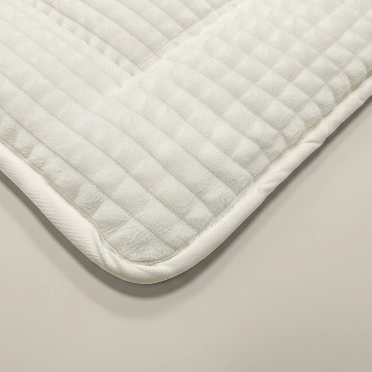 Macro close-up of the soft teddy check pattern of the Zelesta Special Teddy Check Duvet in Cream